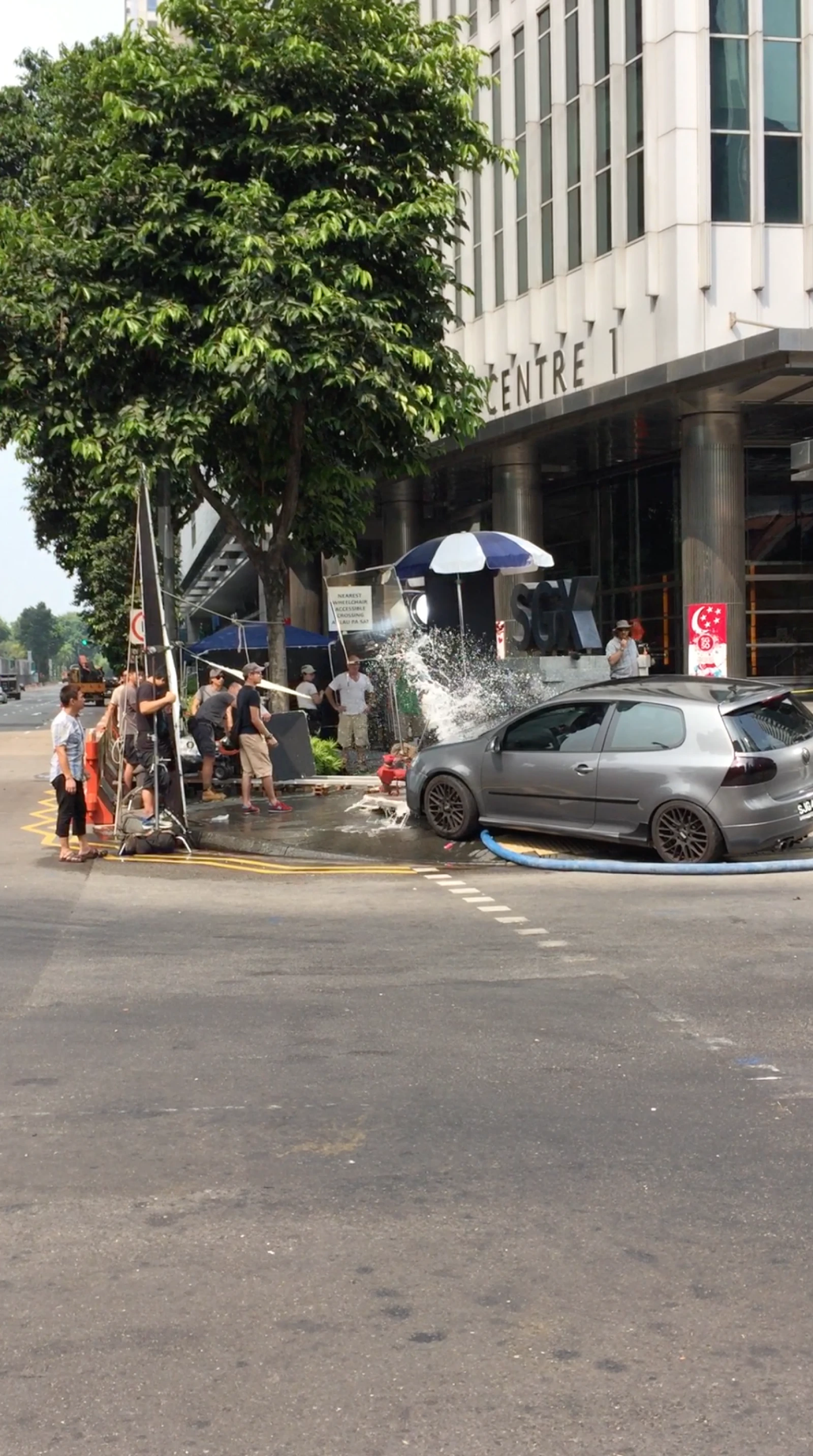 Location crew staging a practical street effect in Singapore
